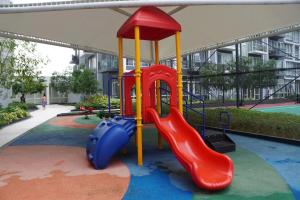 a playground in a building with a slide and a slideintend at One Pacific Residences by Hiverooms in Lapu Lapu City