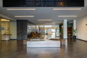 a lobby with a couch in the middle of a building at City Express Junior by Marriott Bogota Aeropuerto in Bogotá