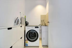 a washer and dryer in a white laundry room at Wake Up in Front of Water Bay Beckons- 2B2B1C in Melbourne