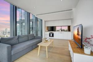 a living room with a couch and a table at Wake Up in Front of Water Bay Beckons- 2B2B1C in Melbourne