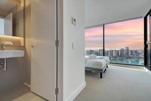 a bedroom with a bed and a view of a city at Wake Up in Front of Water Bay Beckons- 2B2B1C in Melbourne