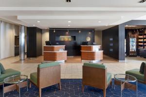 a lobby with chairs and tables in a hotel at Courtyard Long Beach Airport in Long Beach