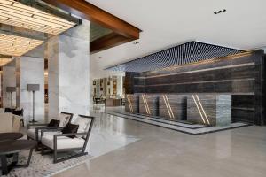 a lobby with two chairs and a fireplace at Lagos Marriott Hotel Ikeja in Lagos