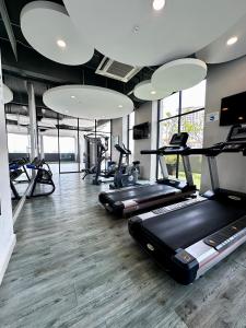 a gym with several treadmills and elliptical machines at Jazz Suites Seaview with Bathtub - 1603 in Tanjong Tokong