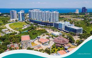 an aerial view of a city with buildings and the ocean at 8 Newtown Boulevard by Hiverooms in Lapu Lapu City