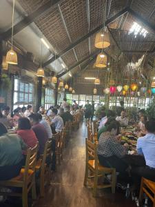 a group of people eating in a restaurant at Camellia Hotel in Ninh Binh