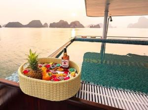 a basket of food and a bottle of beer on a boat at Ha Long Bay 1 Day 5 star in Hanoi