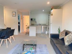 a living room with a couch and a table at 2 Bedroom house in Hamilton Central in Hamilton