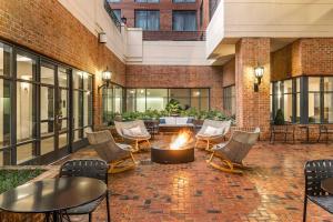 an outdoor patio with chairs and a fire pit at Sheraton Suites Old Town Alexandria in Alexandria