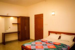 a bedroom with a bed and a cabinet in it at NEST RESORTS in Athirappilly