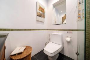 a bathroom with a white toilet and a sink at Kamala Beach Estate Resort - SHA Extra Plus in Kamala Beach