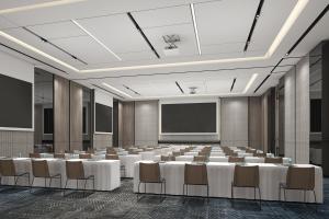 a conference room with tables and chairs and a screen at AC Hotel by Marriott Chengdu North in Chengdu