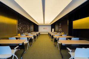 a classroom with tables and chairs and a chalkboard at CitiGO Hotel Hongqiao Shanghai in Shanghai