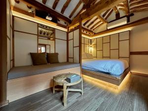 a room with two beds and a table in it at Luxury hanok with private bathtub - SN03 in Seoul