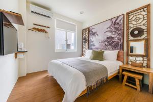 a bedroom with a large bed and a tv at Chin Style Easy Stay in Magong