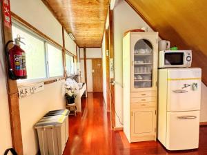a room with a refrigerator with a microwave on it at Iriyama-So in Shimoda