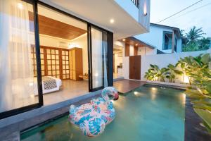 a swimming pool with a rubber duck in a house at Omkara Dharman Ubud Villa By Omkara Experience in Ubud