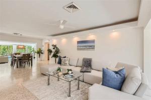 uma sala de estar com um sofá branco e uma mesa em Cozy House Lauderdale By the Sea em Fort Lauderdale