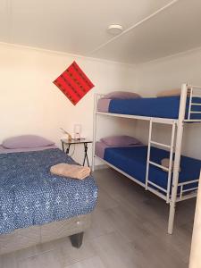 a room with two bunk beds and a table at Misky Wasi in San Pedro de Atacama