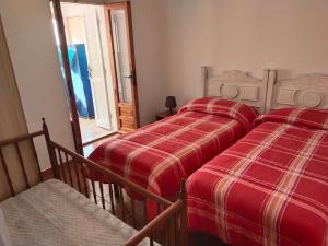 カーラゴノネにあるAppartamento Cala Gononeのベッドルーム1室(隣り合わせのベッド2台付)