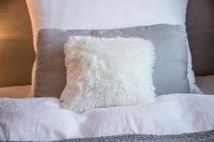 a white pillow sitting on top of a bed at Haus Weitblick in Fieberbrunn