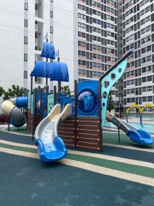 a playground with a slide in a park at jugi suite @ Horizon Sepang KLIA in Sepang