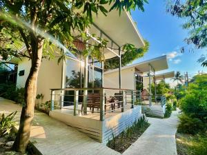 a house with glass doors and a porch at Beach Jungle in Ko Chang