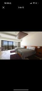a bedroom with a bed and a view of the ocean at Habitación 416 Sonata in Lomas de Angelopolis