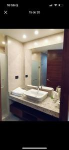 a bathroom with a sink and a large mirror at Habitación 416 Sonata in Lomas de Angelopolis