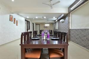 a dining room with a long table and chairs at the indigo premium in Noida