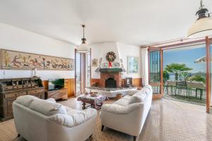 a living room with two couches and a fireplace at Il Poggio Radioso Lake View & Garden - Happy Rentals in Nebbiuno