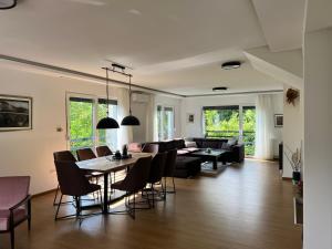 a living room with a couch and a table and chairs at Hillside Villa in Sarajevo