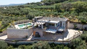 an aerial view of a house with a swimming pool at Villa Lady Dafni with private heated pool in Maleme