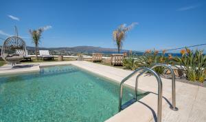 una piscina con un pasamanos de metal al lado en Villa Lady Dafni with private heated pool en Maleme