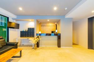 a living room with a couch and a table at JA Hotel Namba-SOUTH難波南 in Osaka