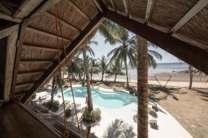 a view of the beach from a resort window at The Beach House Ocam Ocam in Busuanga