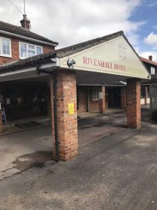 a brick building with a sign that reads renal hospital at OYO The Rivenhall Hotel in Witham