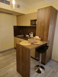 a kitchen with a counter with a stool in it at Bizi House Accommodation 2 in Drobeta-Turnu Severin