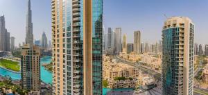 an aerial view of a city with tall buildings at Stunning 1-Bedroom Apartment with full Burj Khalifa View - 5-min walk to Dubai Mall in Dubai