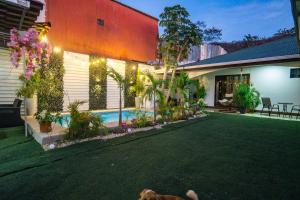 a house with a dog laying in the yard at Casa Nella in Tamarindo