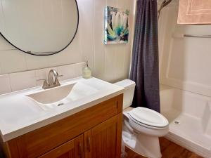a bathroom with a sink and a toilet and a mirror at North Shore of Maui - 2bd-2bath in Paia
