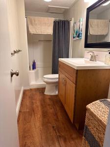 a bathroom with a toilet and a sink and a tub at North Shore of Maui - 2bd-2bath in Paia
