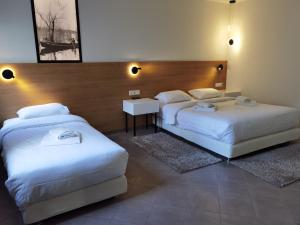 A bed or beds in a room at Z Inn Ioannina