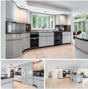 a large kitchen with white cabinets and black appliances at Luxury Mansion Rentals in Niskayuna, NY (USA) in Schenectady