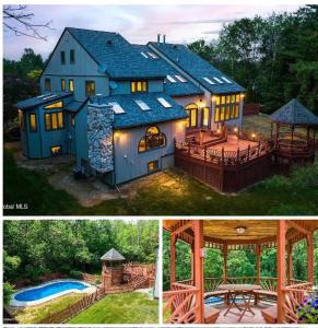 a large blue house with a deck and a gazebo at Luxury Mansion Rentals in Niskayuna, NY (USA) in Schenectady