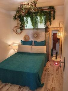 a bedroom with a bed with a green comforter at apartamento playa surf cullera in Cullera