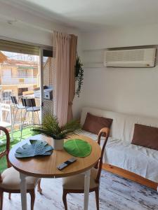 a living room with a table and a couch at apartamento playa surf cullera in Cullera