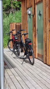 two bikes are parked on a wooden deck at Koppes Mølle B&B - naturnær overnatning in Borup