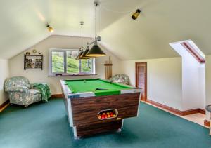 a living room with a pool table in it at 2 Derw Cottages in Trefeglwys