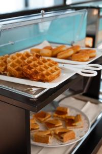 a display case with waffles and other food items at Hotel Niagara in Lido di Jesolo